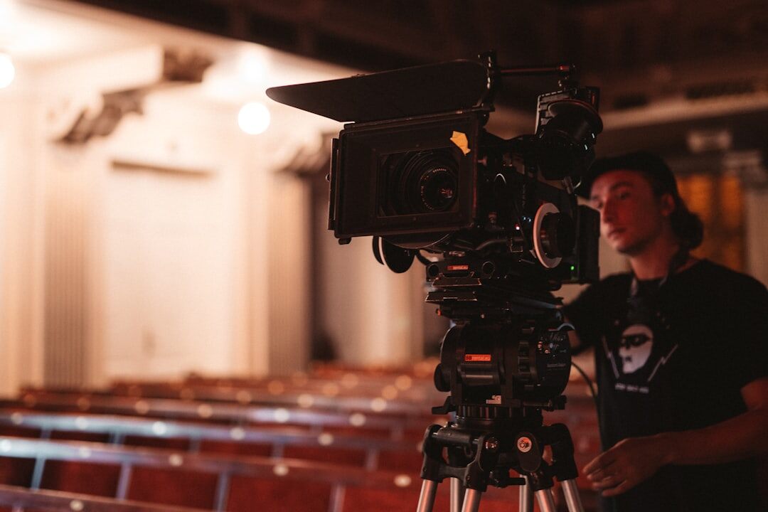 Cinematographer framing a shot through a camera viewfinder